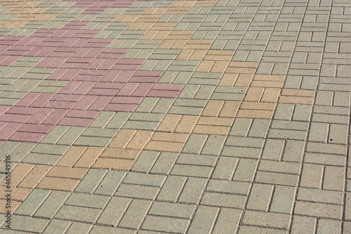 Multicolored background of paving slabs on a city street.