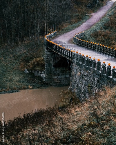 Old bridge made of rocks. Multiple halloween pumpkins on the edge. Halikko, Salo, Finland photo