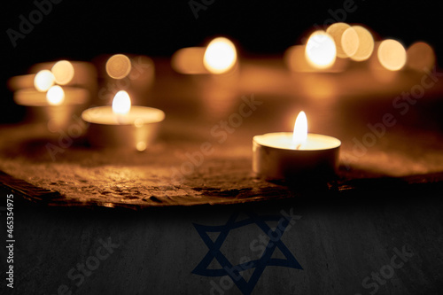 Candles burning over the Star of David in memory of the dead. A symbol of remembrance of the victims of the genocide of the Jew