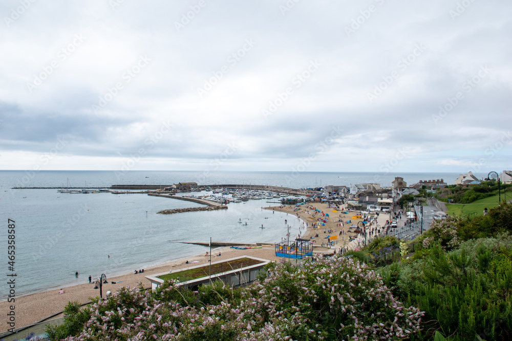 Views of Cobb harbour and sandy beach at Lyme Regis, in Dorset, south England
