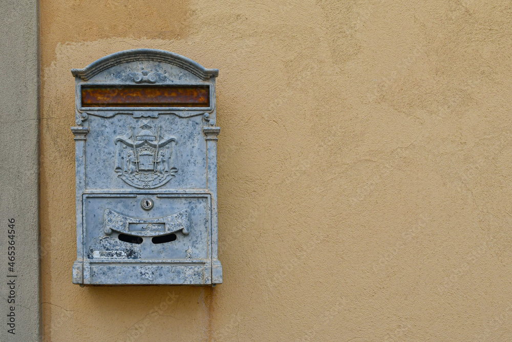 Close-up of a rusty metal mailbox on the wall of an old building, Italy