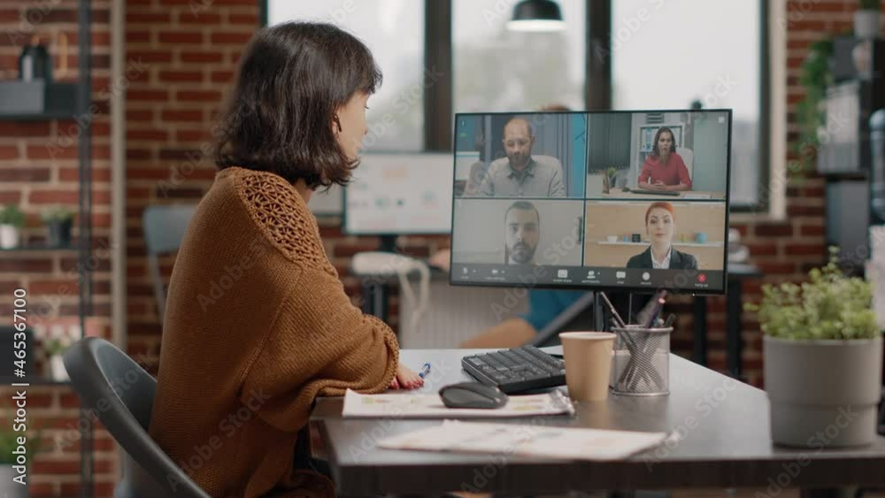 Entrepreneur using video call on computer to talk to colleagues about marketing strategy. Employee attending business meeting with workmates, talking about presentation and project Entrepreneur using video call on computer to talk to colleagues about marketing strategy. Employee attending business meeting with workmates, talking about presentation and project