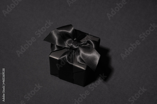 Black gift box on black background.