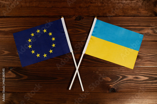 Flag of European Union and flag of Ukraine crossed with each other. The image illustrates the relationship between countries. Photography for video news on TV and articles on the Internet and media.