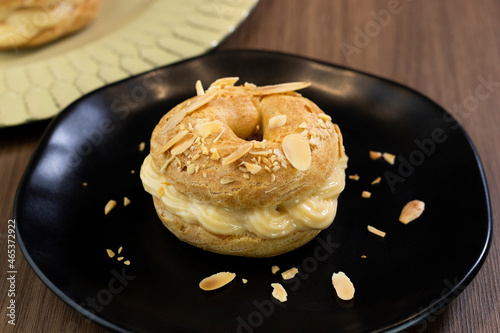 Traditional and classic dessert Paris Brest on black plate photo