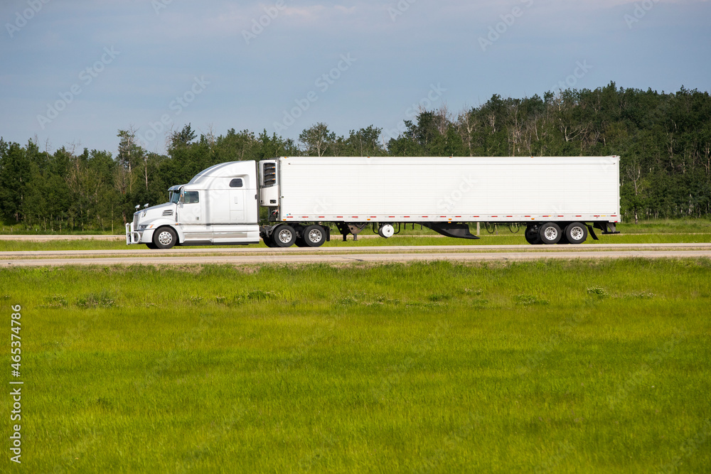 Heavy Cargo on the Road. A truck hauling freight along a highway Heavy Cargo on the Road. A truck hauling freight along a highway