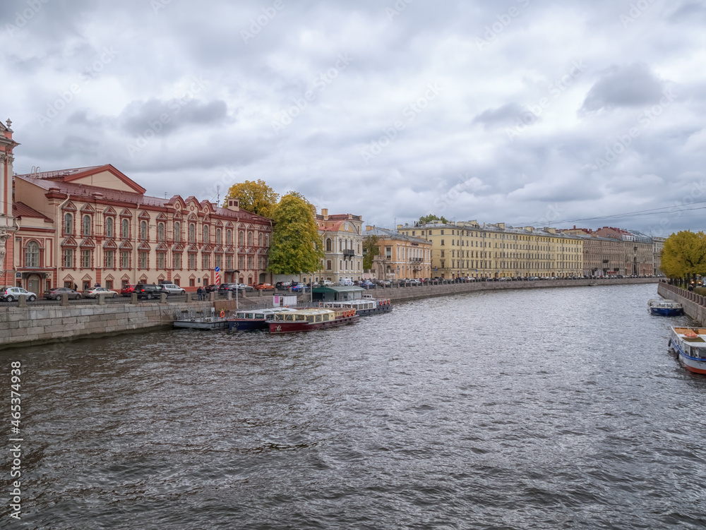 River cityscape with boats and former private residences of Russian nobility on the embankment of river Fontanka