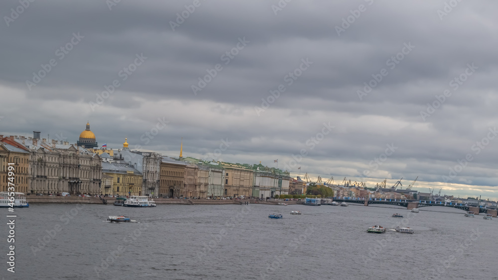 River landscape with boats, a bridge, ancient buildings on the embankment of Neva, a river flows through the city of Sankt-Petersburg