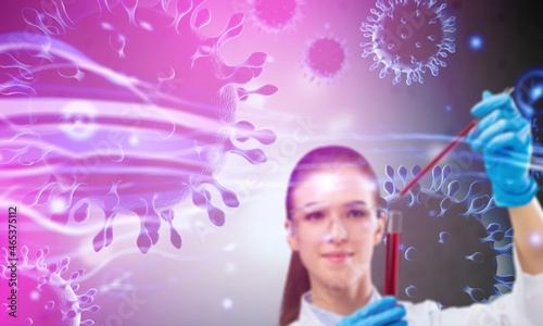 Blurred chemist holding a test-tube in futuristic scientific background with infographics.