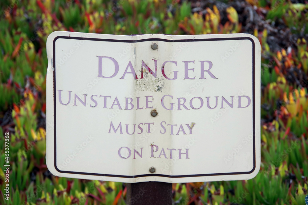 Posted sign on a nature walk DANGER  UNSTABLE GROUND MUST STAY ON PATH