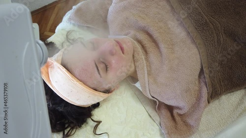 Acne treatment of problematic face skin with ozone facial steamer in spa or dermatology center. Steam for smooth skin and open pores before applying face mask photo