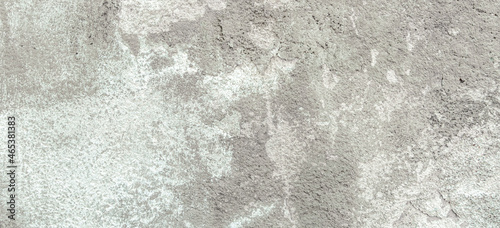 Grey plaster wall with peel grey stucco texture background. Decayed cracked rough abstract wall surface