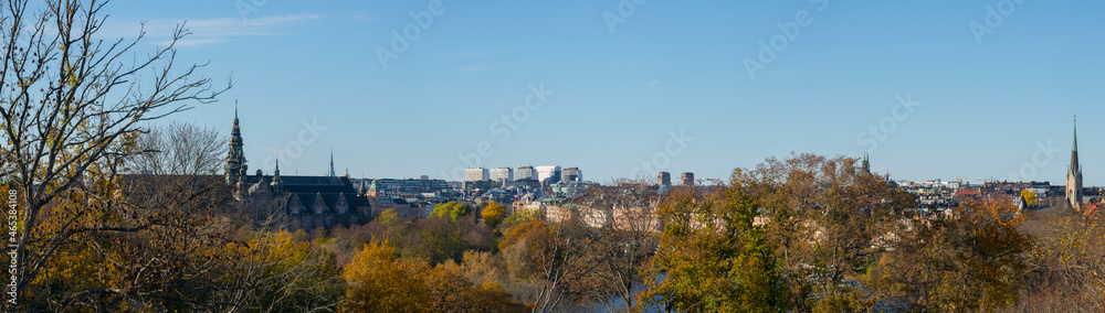 Skyline with the old Gothic museum building with towers from 1873 and the east and north districts of Stockholm a colorful autumn day