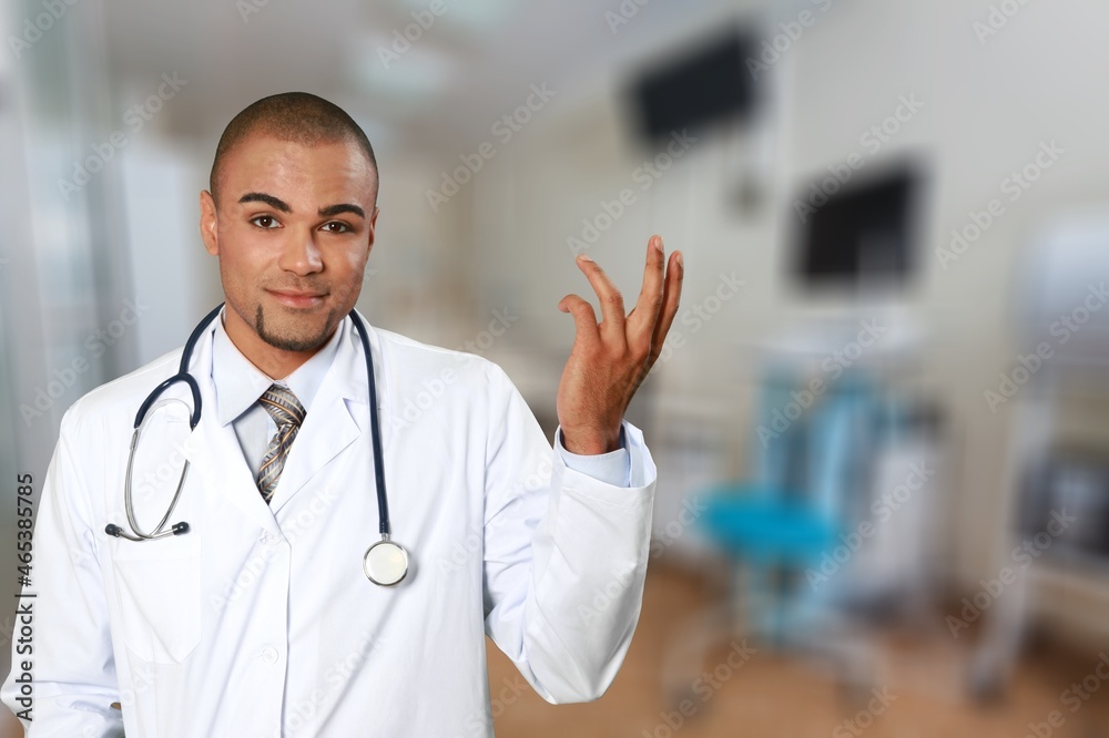 Smiling doctor wearing medical coat looking at camera. Smiling doctor wearing medical coat looking at camera.