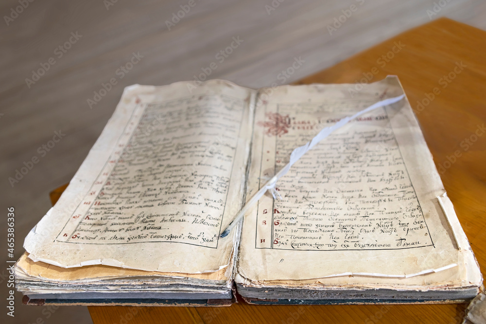 Fototapeta premium Antique book lying on the table in a library room