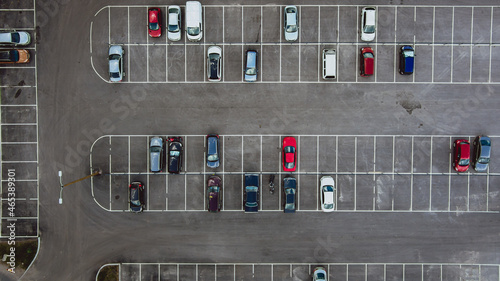 Car parking seen from above. Aerial view above multicolored cars on parking - drone view