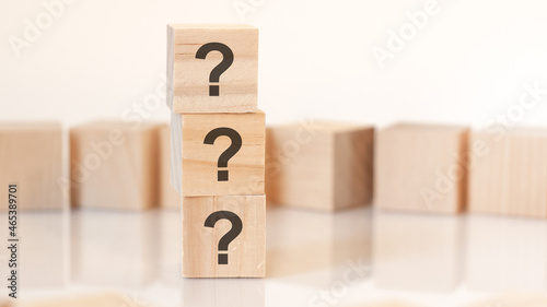 wooden blocks with lhe three question marks, concept photo