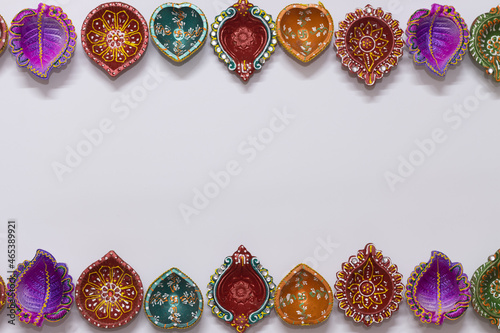 Eco Friendly Handmade Handcrafted earthen floral Clay Diya Deep Dia arranged as a two side border frame background with copy space