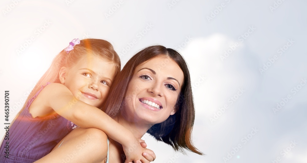 Young happy woman piggybacking a little girl. Young happy woman piggybacking a little girl.