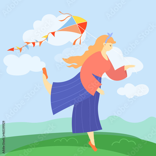 Happy cute girl flying a kite in the wind