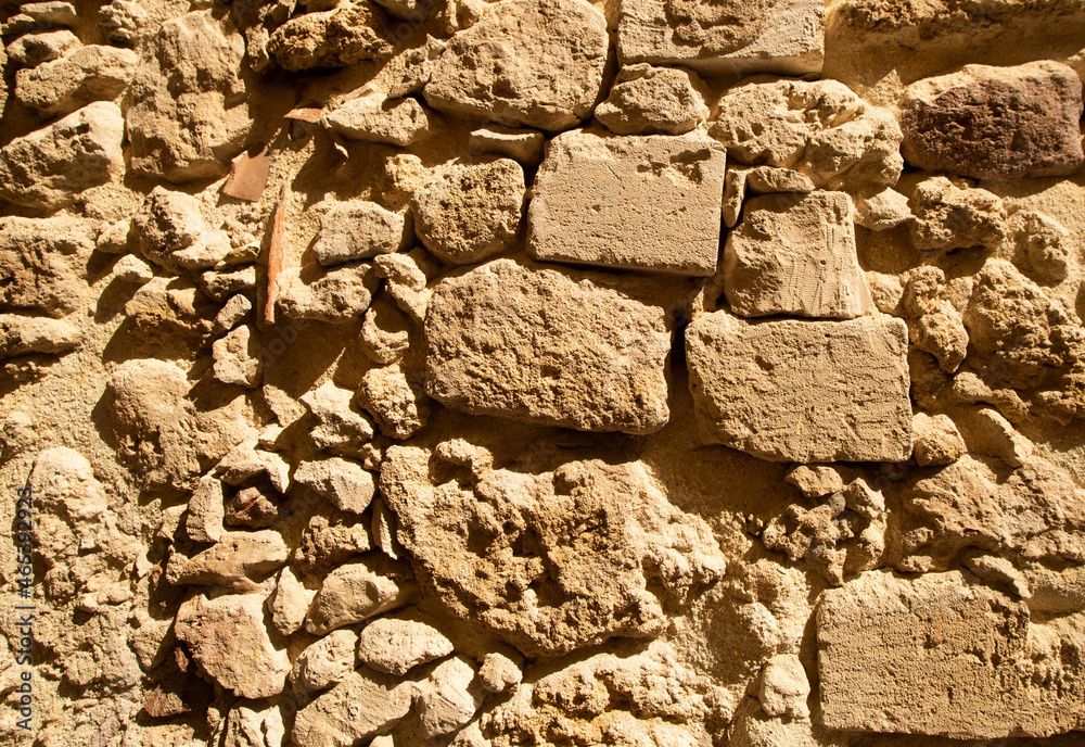 Fototapeta premium Yellow orange warm sandstone limestone wall abstract background.