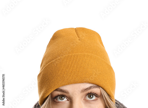 Young woman in beanie hat on white background