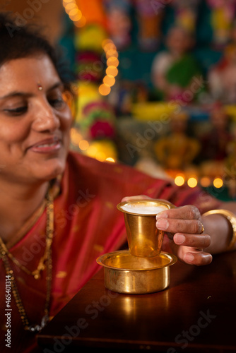Indian woman enjoying south Indian filter coffee  photo