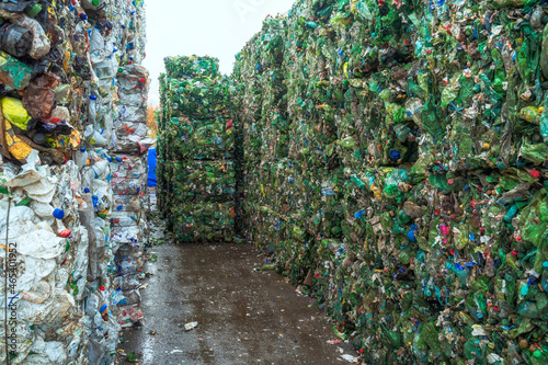 Bundle of pressed plastic bottles prepared for a garbage recycling on waste recycling plant. Pollution problem