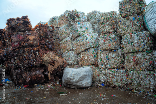 Bundle of pressed plastic bottles prepared for a garbage recycling on waste recycling plant. Camera moves forward. Pollution problem. Stabilized video