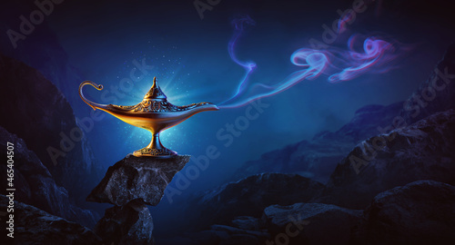 Golden magic lamp on bright and blue background
