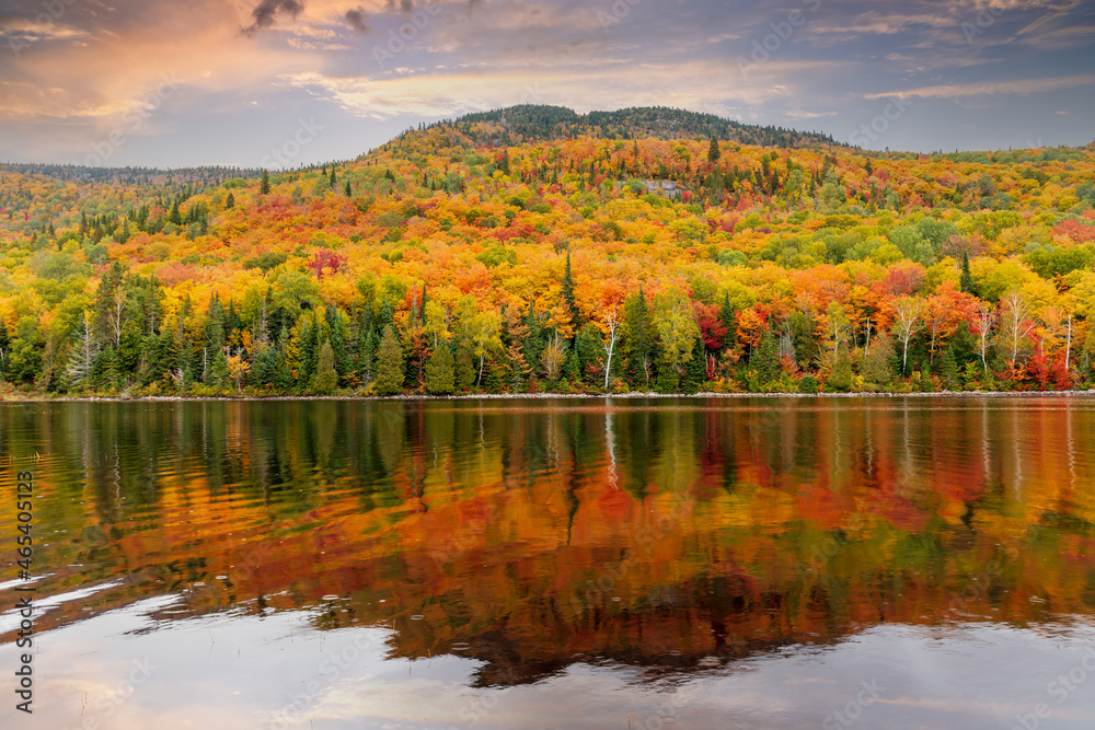 Mount Kaaikop in the background with Lac Legault showing the Autumn fall colors in the water reflection, Quebec, Canada.