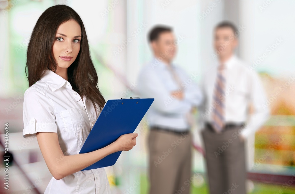 Programmers cooperating at IT company developing apps on office background Programmers cooperating at IT company developing apps on office background