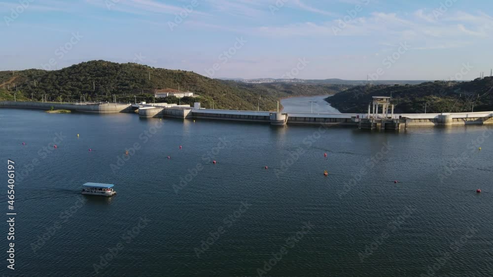 Drone flying over Alqueva dam with river in background, Portugal. Aerial forward Drone flying over Alqueva dam with river in background, Portugal. Aerial forward