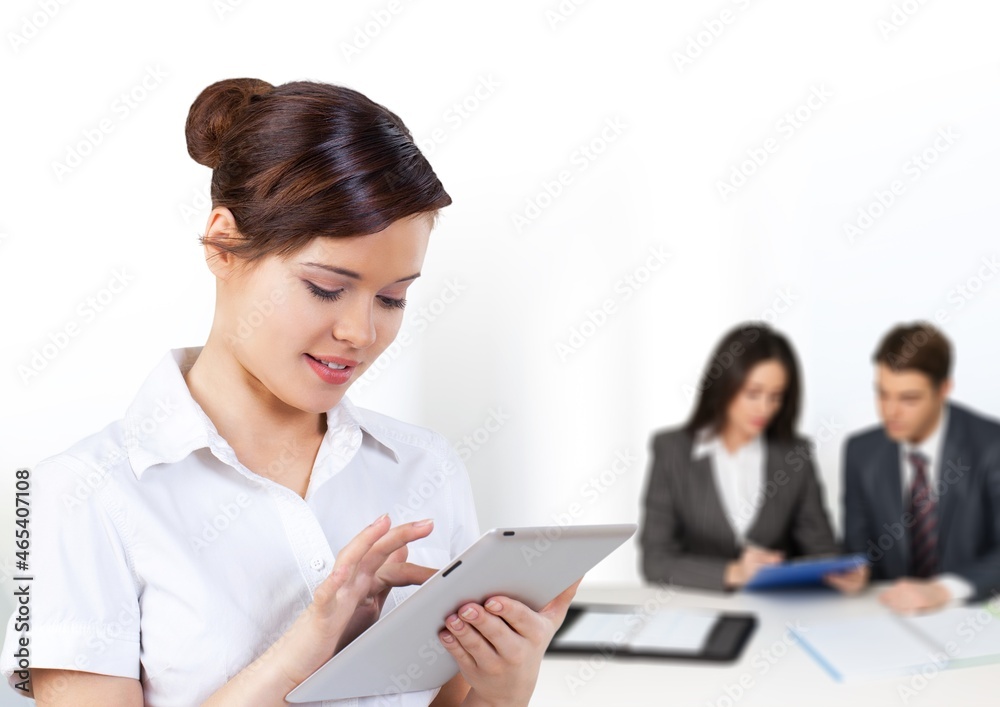 Programmers cooperating at IT company developing apps on office background Programmers cooperating at IT company developing apps on office background
