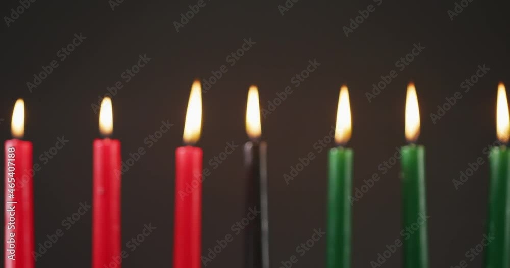 Composition of halloween green, black and red lit candles against black background Composition of halloween green, black and red lit candles against black background