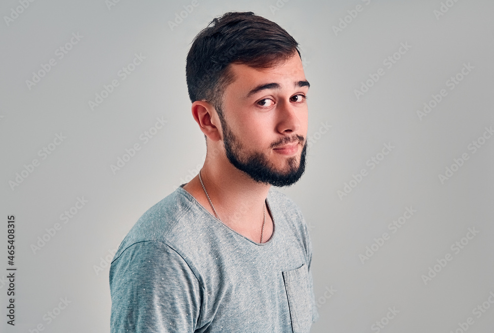 Young man in the studio on a gray background Young man in the studio on a gray background