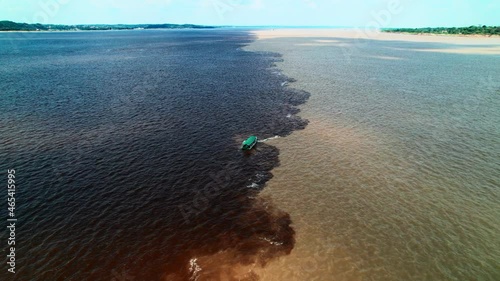 The confluence of two dark and light waters of the Encontro das Aguas and Rio Negro straits. photo