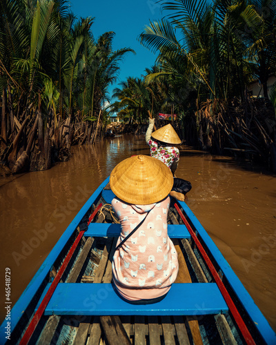 riding a boat or kayak down the mekong river delta in vietnam