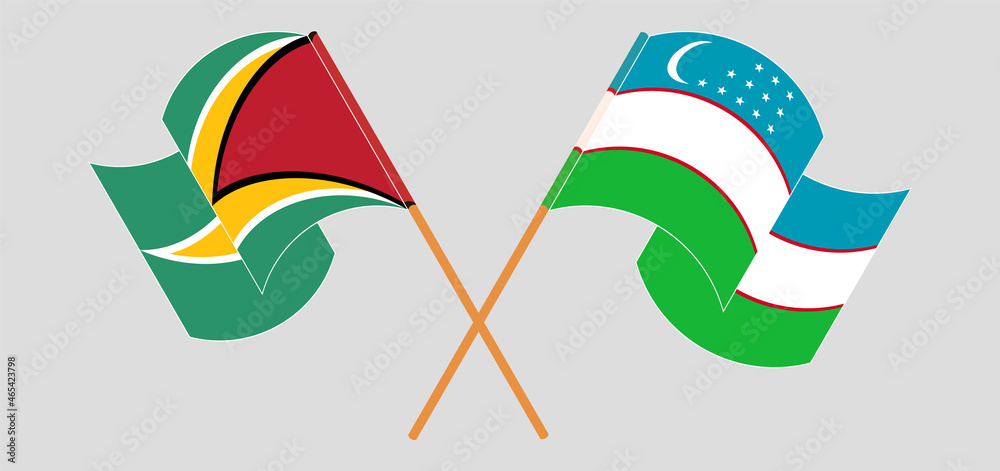 Crossed and waving flags of Guyana and Uzbekistan