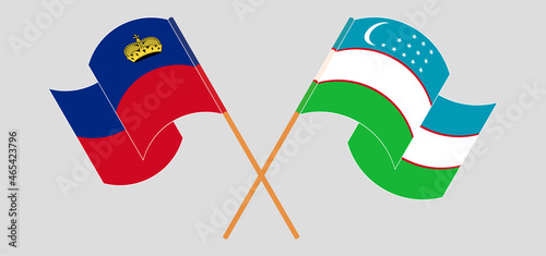 Crossed and waving flags of Liechtenstein and Uzbekistan