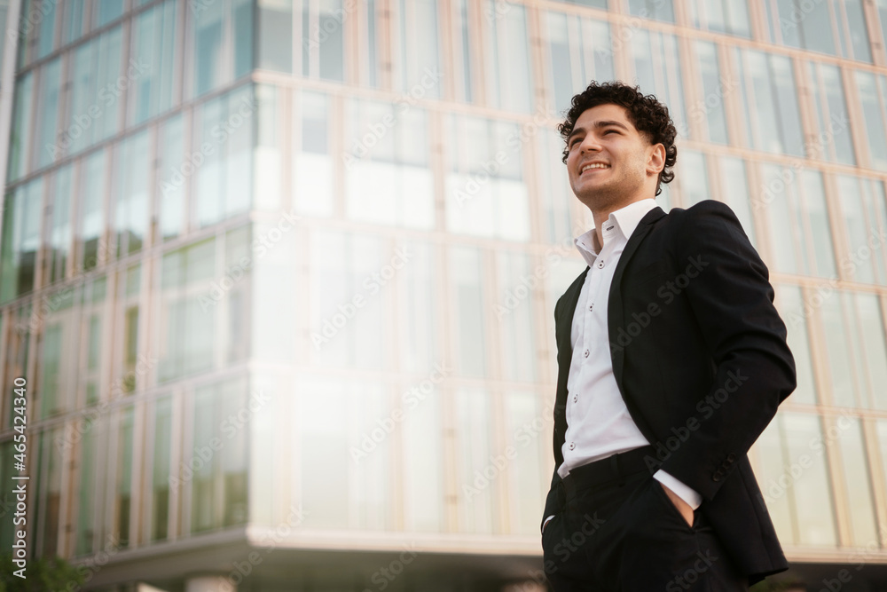 The manager is a man in a business suit near the office. A professional financier goes to work and looks away.