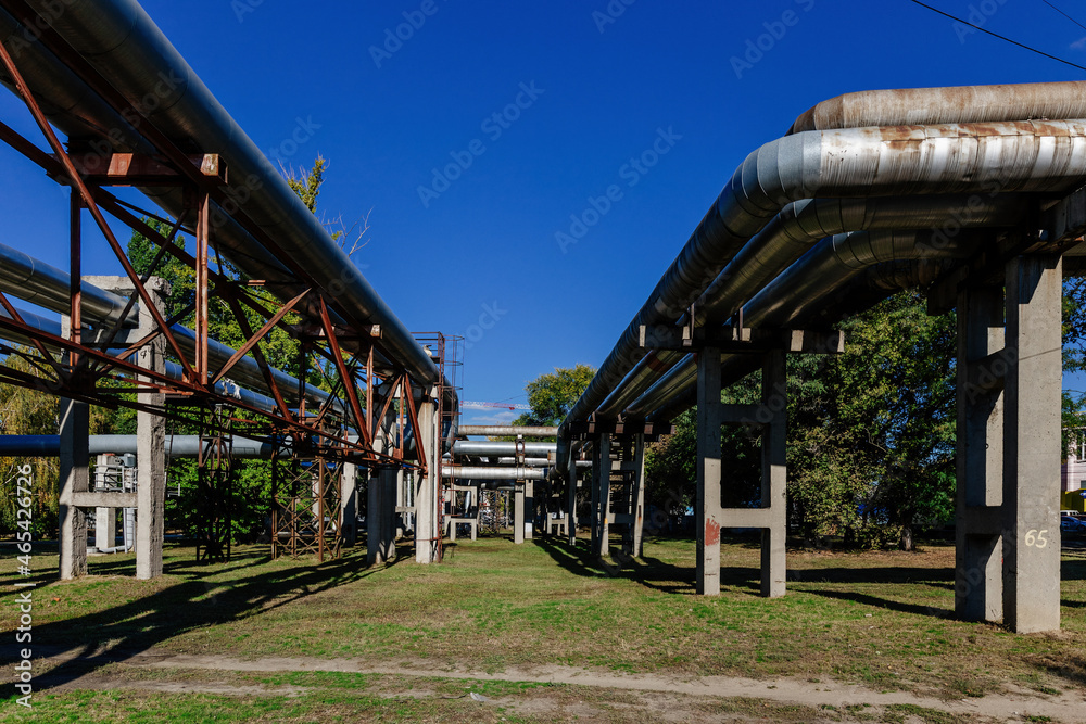 Steel pipelines outgoing from the plant at sunny day Steel pipelines outgoing from the plant at sunny day