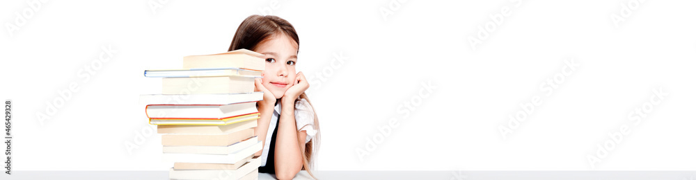 Young cute girl sitting at the table and reading a book Young cute girl sitting at the table and reading a book