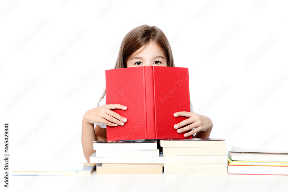 Young cute girl sitting at the table and reading a book Young cute girl sitting at the table and reading a book