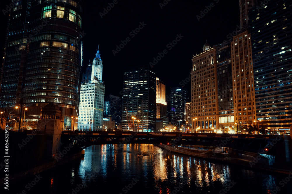 wide shot of downtown chicago river at night with city skyline in background