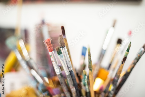 Used paintbrushes standing in a cup