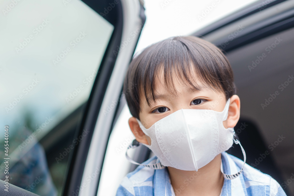 Asian kid boy with mask outdoor at school.safety, protect in travel.people wearing masks in the car to school outdoor masked reopen school, Airpots, Train station, bus stop.Student child with masked.