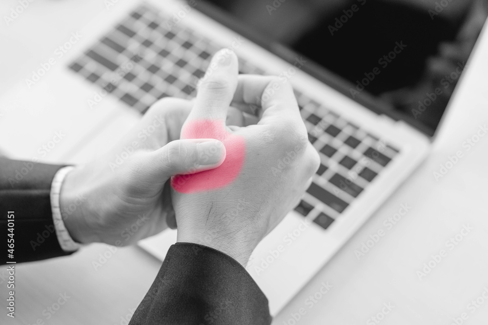 business man having problem trigger finger in office.Hand trigger