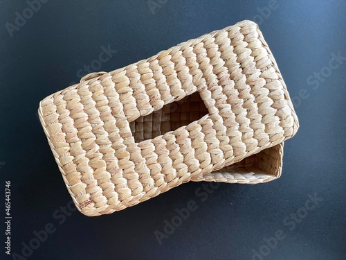Handmade woven napkin paper box made from dried water hyacinth, woven tissue box for home use and decoration, weaved tissue paper box on black background 