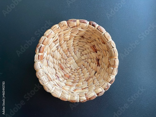 Handmade round shape basket made from dried water hyacinth, woven basket for home use and decoration, weaved basket on black background 